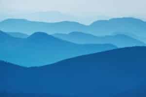 Layers of blue mountains creating a serene, misty landscape.
