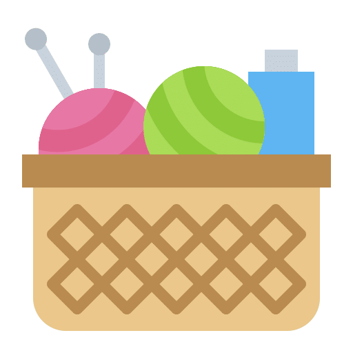 A basket with yarn balls, knitting needles, and a crochet hook.