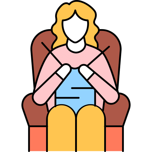 A person sitting in a chair knitting with yarn and needles.
